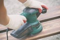 Sanding a wood with orbital sander Royalty Free Stock Photo