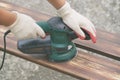 Sanding a wood with orbital sander Royalty Free Stock Photo