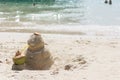 Sandman with coconut drink on the beach.