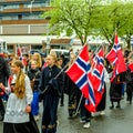 Young Girls or Schoolgirls in Traditional Dress Carrying Flags In Norwegian Independence Day Parade