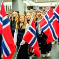Young Girls or Schoolgirls in Traditional Dress Carrying Flags In Norwegian Independence Day Parade