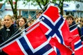 Young Men And Women Carrying Flags At Norways Independence Celebration Parade