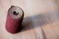 Sandpaper roll on a wooden table Royalty Free Stock Photo