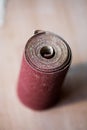 Sandpaper roll on a wooden table Royalty Free Stock Photo