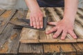 Sandpaper wood treatment/type of male hands processing sandpaper wood