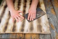 Sandpaper wood treatment/type of male hands processing sandpaper wood