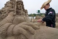 Sandsculpture artists working on his sculpture