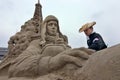 Sandsculpture artists working on his sculpture