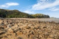 Sandstone boulders on sandy beach at low tide in Abel Tasman National Park, New Zealand Royalty Free Stock Photo