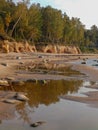 Sandstone cliffs on the seashore, beautiful reflections in the water