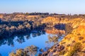 Sandstone eroding cliffs over houseboat. Royalty Free Stock Photo