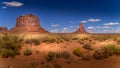 The sandstone formations of Merrick Butte and East Mitten Butte in the desert landscape of Monument Valley Royalty Free Stock Photo