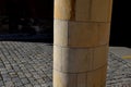 Sandstone lookout column made of sandstone blocks in the shape of a cylinder or ellipse. standing on a sidewalk of granite cubes.