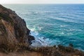 Sandstone path overlooking cliff side, pacfic ocean expanse, and waves on the shore Royalty Free Stock Photo