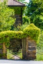 Sandstone portal with lattice gate and ivy