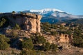 Red rock formation with a snow-capped mountain peak near Santa Fe, New Mexico Royalty Free Stock Photo