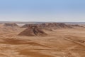 Sandstone rocks on the horizon of the Sahara desert of Tunisia Royalty Free Stock Photo