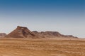 Sandstone rocks on the horizon of the Sahara desert of Tunisia Royalty Free Stock Photo