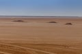 Sandstone rocks on the horizon of the Sahara desert of Tunisia Royalty Free Stock Photo