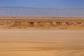 Sandstone rocks in the Sahara desert with the Atlas Mountains on the background in Tunisia Royalty Free Stock Photo