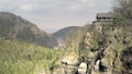 Sandstone rocks with touristic restaurant, rock massifs in forest. View of beautiful valley.