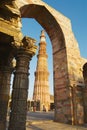 Sandstone tower and gate at the Qutb Minar complex in Delhi, India.