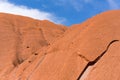 Sandstone Uluru rock on the background of the blue sky