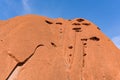 Sandstone Uluru rock on the background of the blue sky