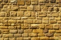 Sandstone wall with sandstones with relief-like, artistic patterns, hatchings and shapes