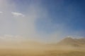 Sandstorm and Rocky Mountains in Distance Royalty Free Stock Photo