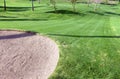 Sandtrap and Manicured grass of golf course Royalty Free Stock Photo