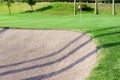 Sandtrap and Manicured grass of golf course Royalty Free Stock Photo