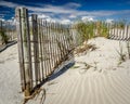 Sandune with Fence and Clouds Royalty Free Stock Photo