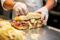 sandwich artist spreading sauerkraut generously on a sub