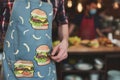 sandwich artist at work, apron with sandwich motif
