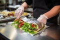 sandwich artist wrapping creation in foil