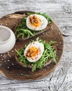 Sandwich with arugula, boiled egg and mustard on a wooden board. Healthy breakfast Royalty Free Stock Photo