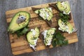 Sandwich with avocado, dark bread and white light cheese on wood Royalty Free Stock Photo