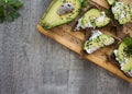 Sandwich with avocado, dark bread and white light cheese on wood Royalty Free Stock Photo