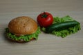 Sandwich with bacon, tomato, cucumber and lettuce in a sesame seed bun Royalty Free Stock Photo