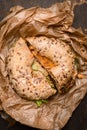 Sandwich on a Bagel with chiken and salad leaves and Cheese on rustic wooden background, close up, top view Royalty Free Stock Photo