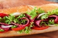 Sandwich baguette tomato salami tomato sauce and herbs