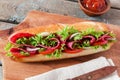 Sandwich baguette tomato salami tomato sauce and herbs