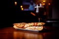 Sandwich in a bar on a wooden table. A tulip glass of beer on the background. Royalty Free Stock Photo