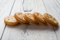 Sandwich biscuits with white cream filling on white wood