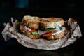 Sandwich on craft paper on black background Royalty Free Stock Photo