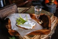 A sandwich of black bread and lard, lying on a tray of the tavern. Garlic, dill, a shot of vodka. Traditional Ukrainian snack