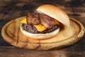 sandwich bread cut in half with meat and cheese burger and bacon on top Royalty Free Stock Photo