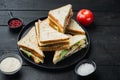 Sandwich bread tomato, lettuce and yellow cheese, on black wooden background Royalty Free Stock Photo