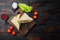 Sandwich bread tomato, lettuce and yellow cheese, on dark wooden background, top view with copy space for text Royalty Free Stock Photo